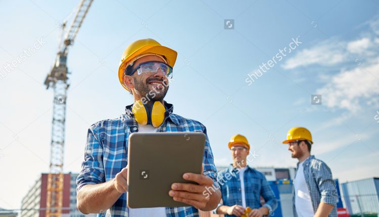 stock-photo-business-building-industry-technology-and-people-concept-smiling-builder-in-hardhat-with-304752284